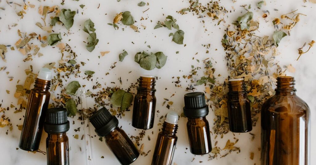 Flat lay of brown glass bottles and dried herbs, perfect for aromatherapy themes.
